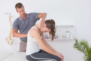 Athlete receiving a movement assessment while a clinician observes ankle and knee alignment